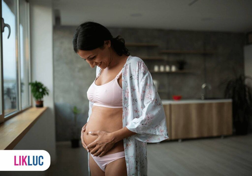 Gestante de 17 semanas olhando a sua barriga