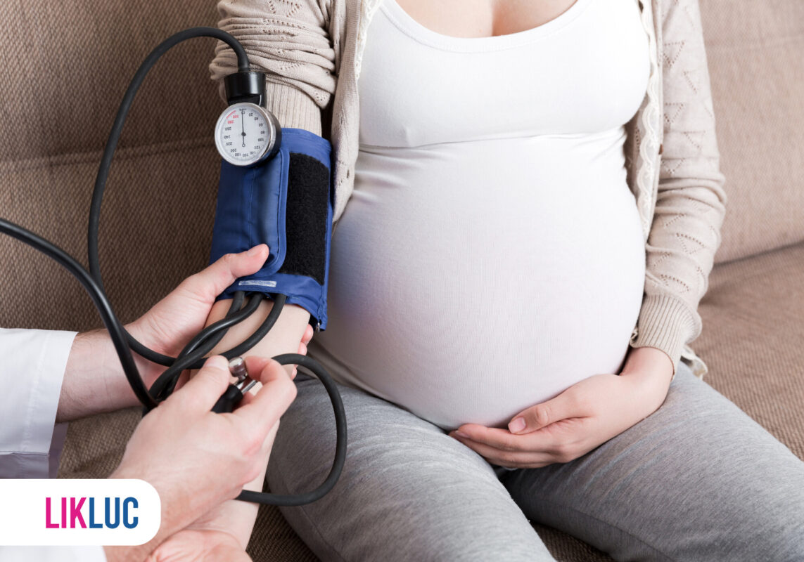 Gestante medindo pressão arterial em consulta médica