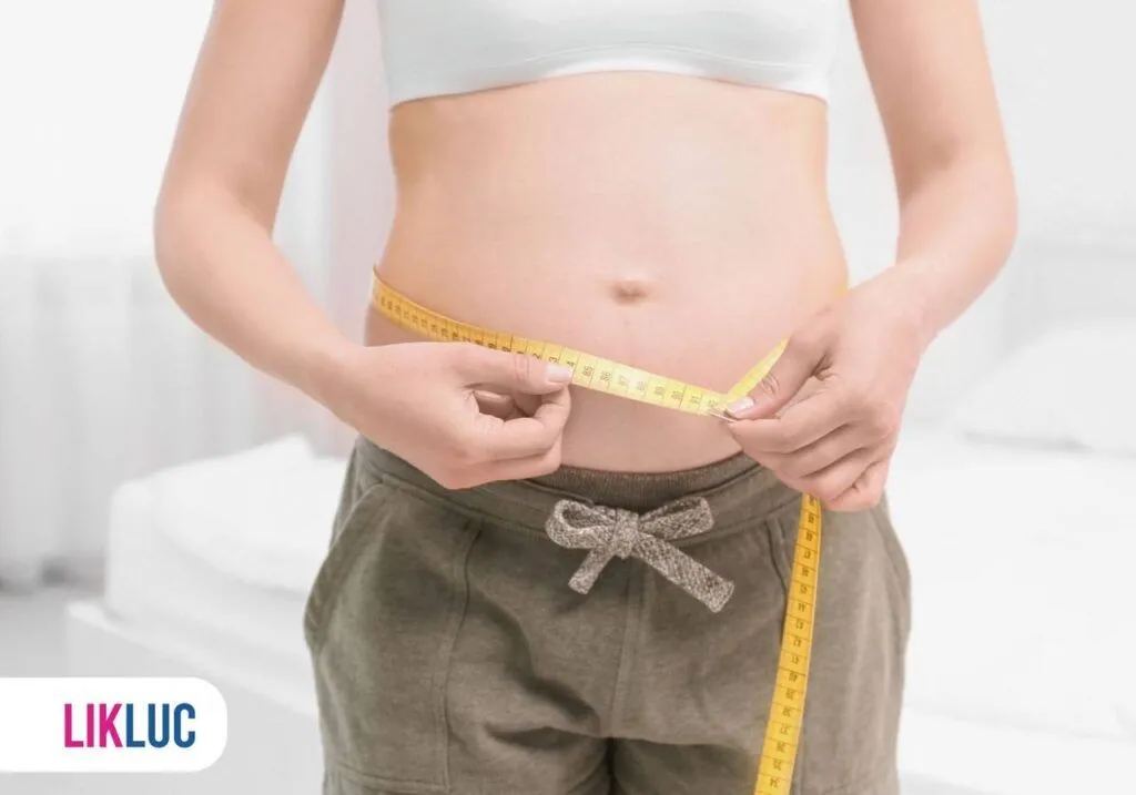 Mulher medindo a barriga de 8 semanas