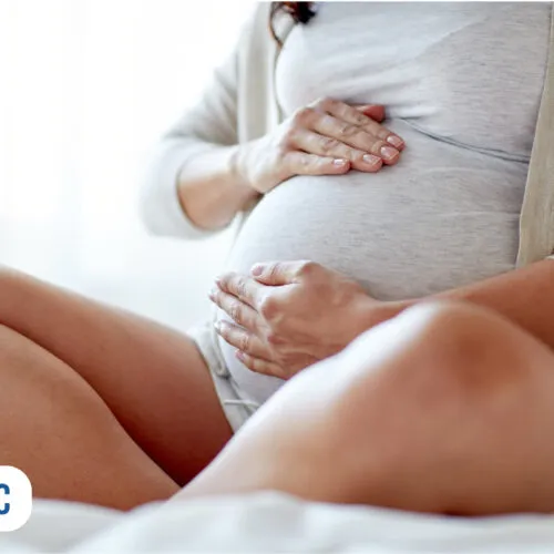 Mulher grávida acariciando a barriga